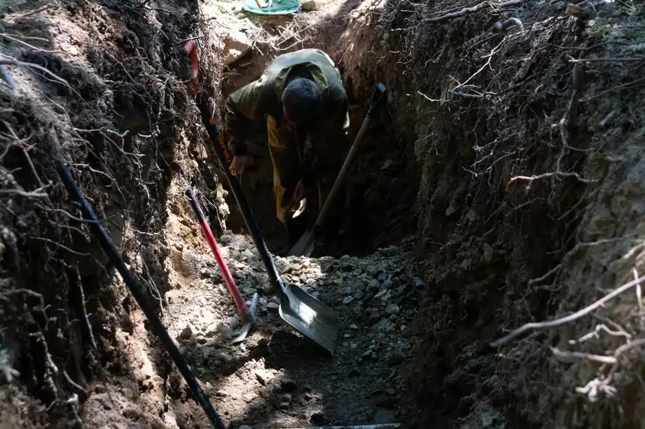 Worker digging for sewer line replacement